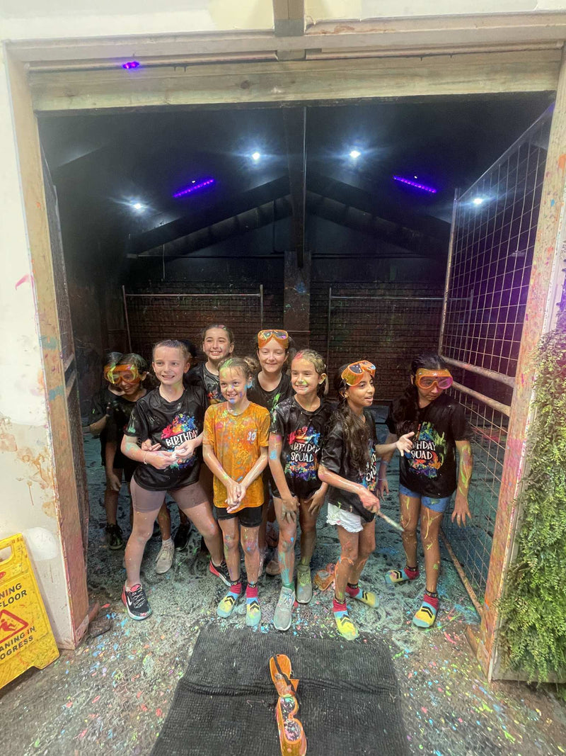 Children posing inside DIY Invasion's Splatter & Splash room 